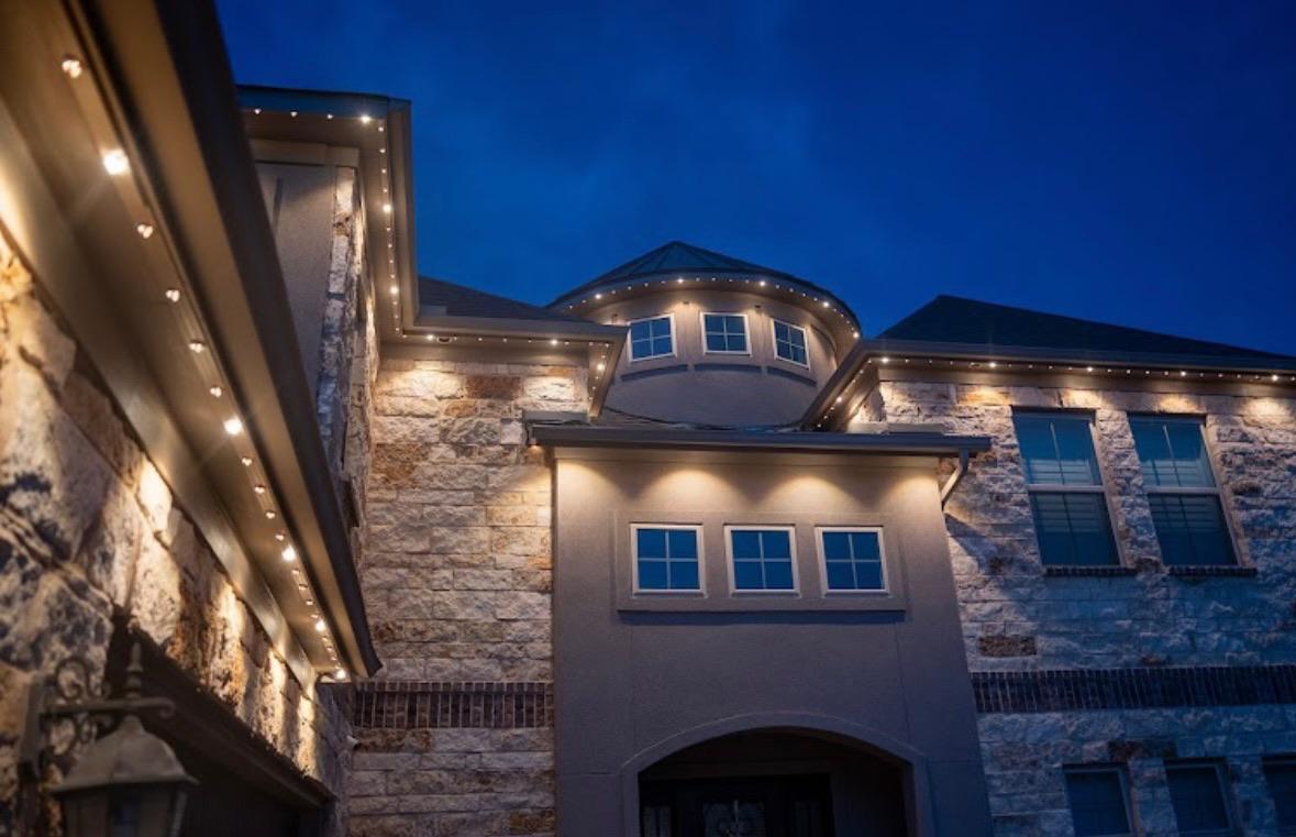 Warm white permanent accent lighting on a Calgary home roofline